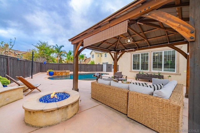 view of patio with a fenced in pool, a gazebo, and an outdoor living space with a fire pit