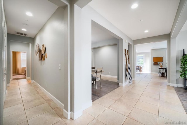 hall with light tile patterned floors