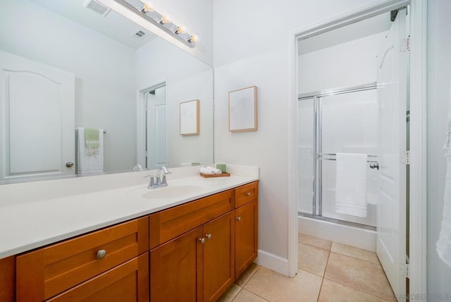 bathroom featuring an enclosed shower, vanity, and tile patterned floors