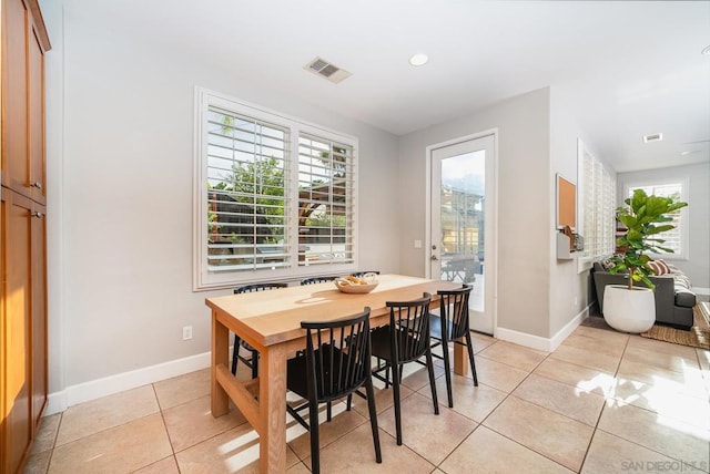 dining space featuring light tile patterned flooring