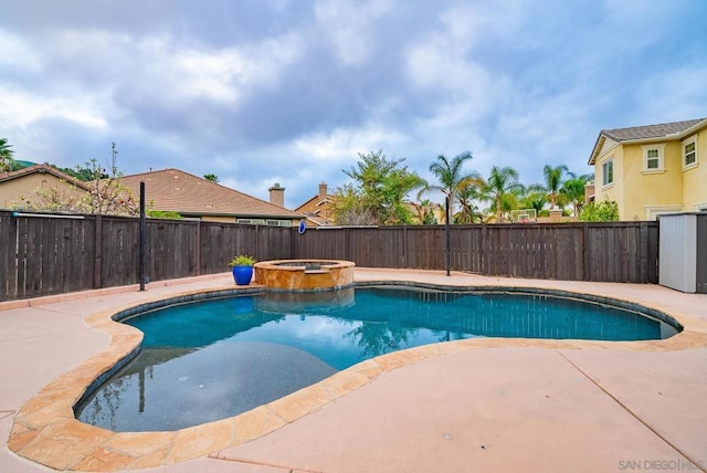 view of pool with an in ground hot tub and a patio area