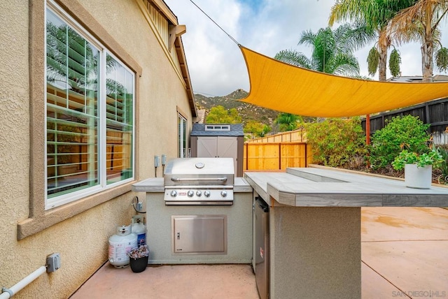 view of patio featuring area for grilling, a storage shed, grilling area, and a mountain view