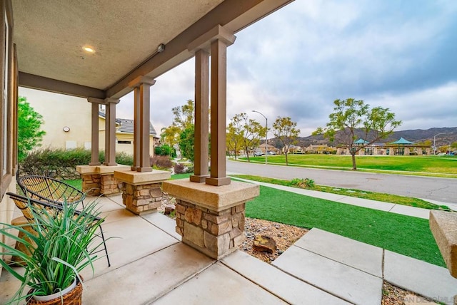 view of patio featuring a mountain view and covered porch