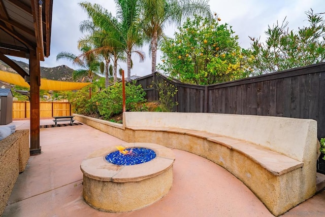 view of patio / terrace featuring an outdoor fire pit