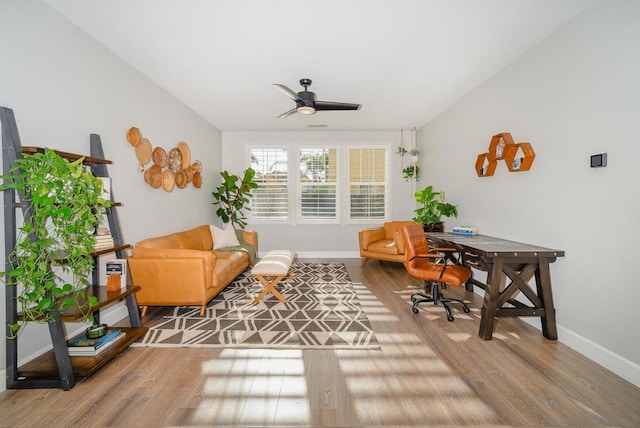 sitting room with wood-type flooring and ceiling fan