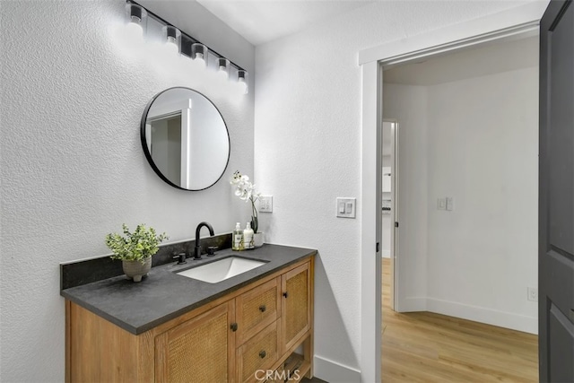 bathroom with hardwood / wood-style flooring and vanity