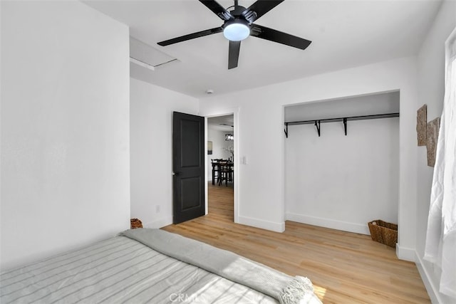 unfurnished bedroom featuring light hardwood / wood-style flooring, a closet, and ceiling fan