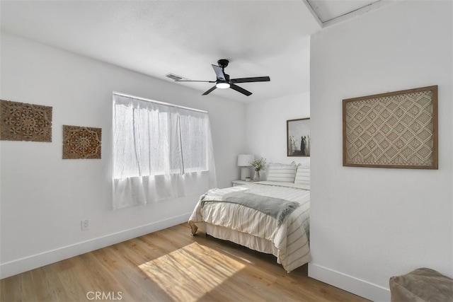 bedroom with wood-type flooring and ceiling fan