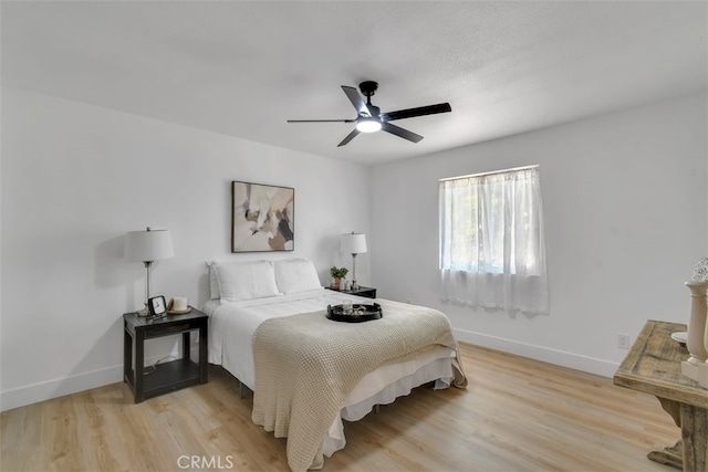 bedroom with ceiling fan and light wood-type flooring