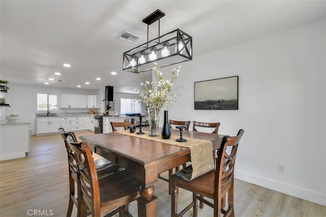 dining area featuring sink and light hardwood / wood-style flooring