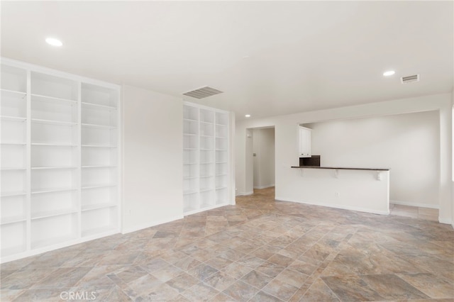 spare room featuring built in shelves