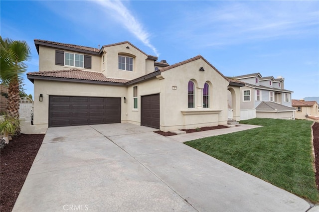 mediterranean / spanish home with a garage and a front yard