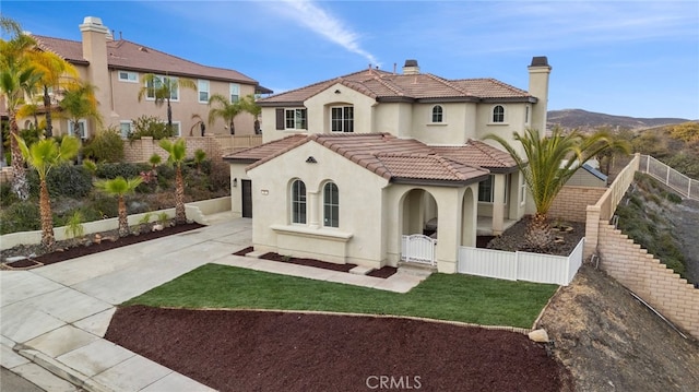 mediterranean / spanish-style house with a mountain view and a garage