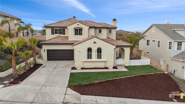 mediterranean / spanish home featuring a garage and a front yard