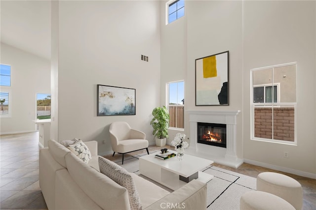 tiled living room featuring a towering ceiling