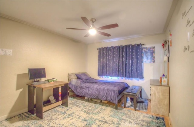 bedroom with ornamental molding and ceiling fan