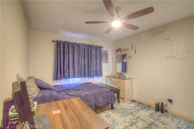 bedroom with ceiling fan, ornamental molding, and hardwood / wood-style floors