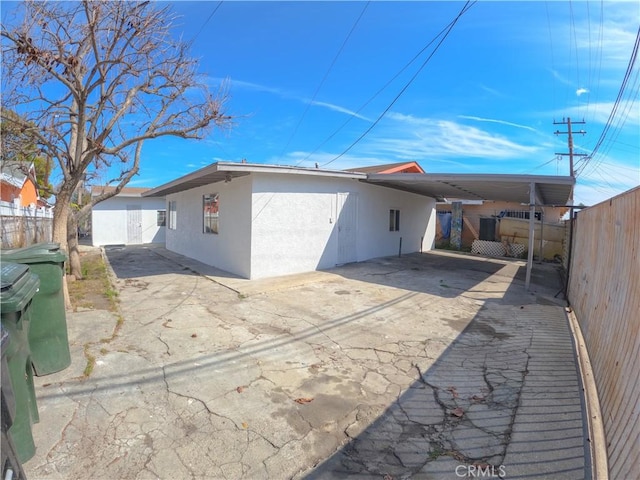 back of property featuring a shed