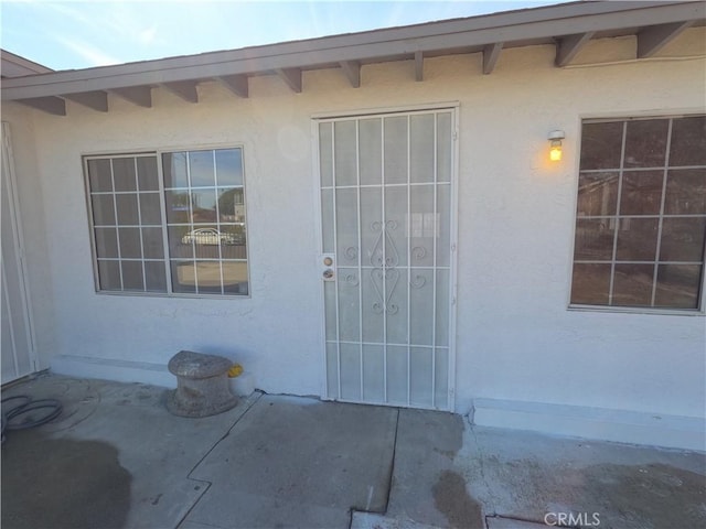 doorway to property with a patio