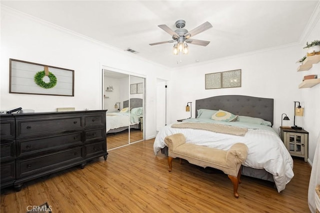 bedroom featuring ornamental molding, hardwood / wood-style floors, and a closet