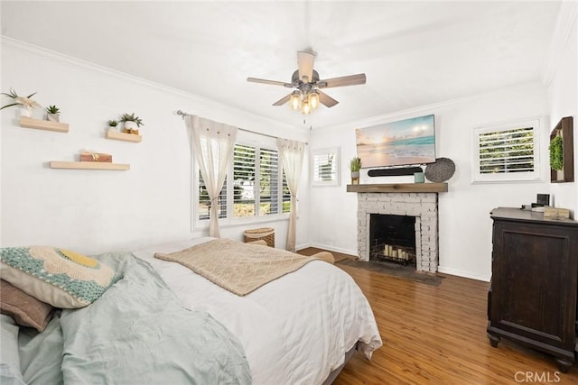 bedroom with hardwood / wood-style floors, crown molding, and ceiling fan