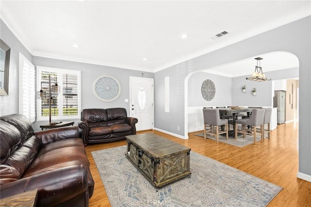 living room with an inviting chandelier and light hardwood / wood-style floors