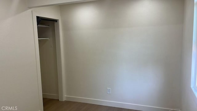 interior space with dark hardwood / wood-style flooring and a closet