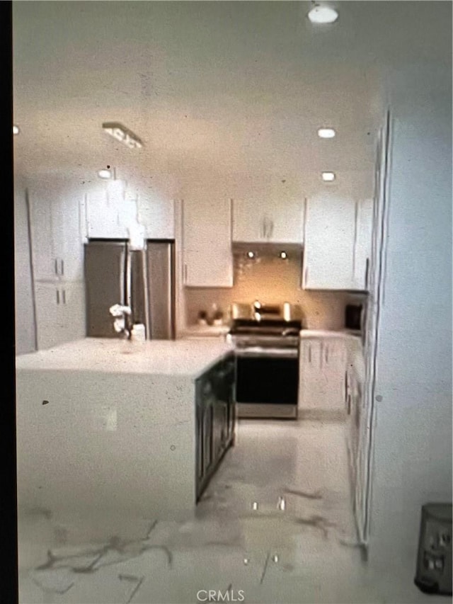 kitchen featuring white cabinetry and appliances with stainless steel finishes