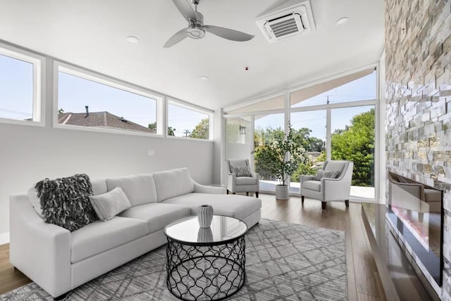 sunroom featuring ceiling fan and vaulted ceiling