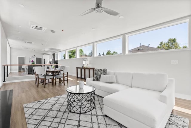 living room with ceiling fan and light wood-type flooring