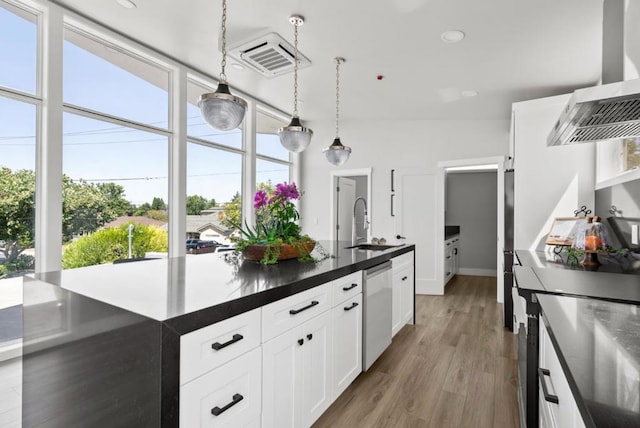 kitchen with pendant lighting, dishwasher, extractor fan, wood-type flooring, and white cabinets