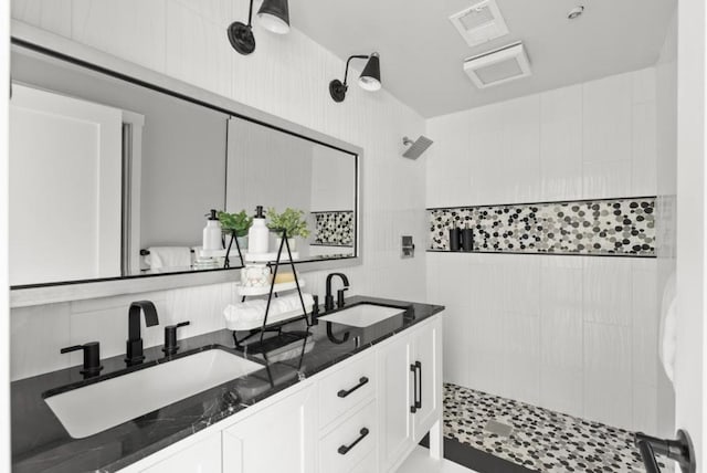 bathroom featuring vanity and a tile shower