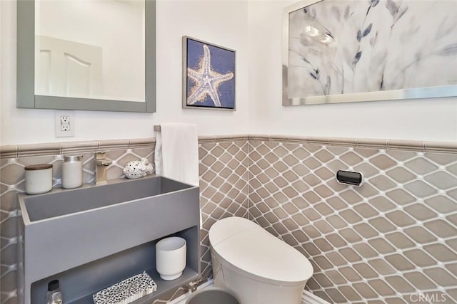 bathroom with tile walls and toilet