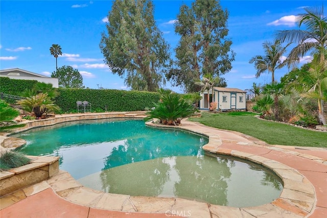 view of swimming pool featuring a lawn and a storage unit