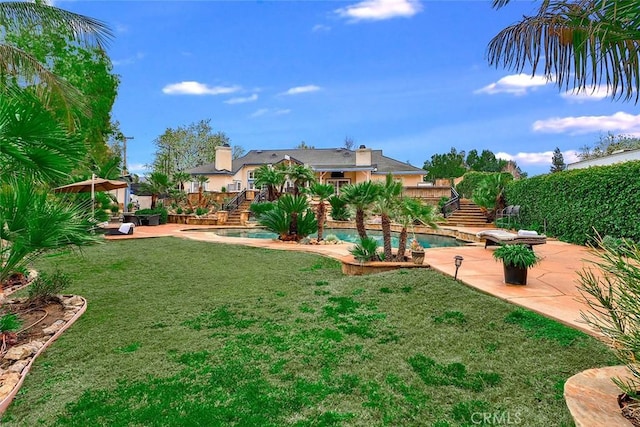 view of yard with a fenced in pool and a patio