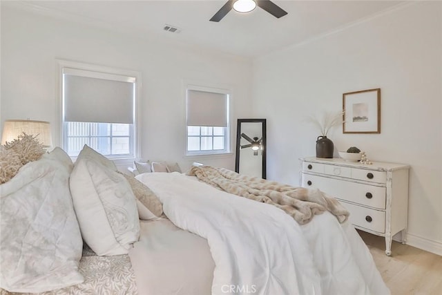 bedroom with ceiling fan and light hardwood / wood-style floors