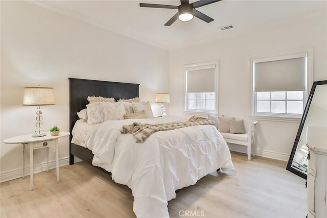 bedroom with crown molding, ceiling fan, and light wood-type flooring