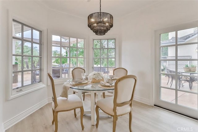 dining room featuring light wood-type flooring and an inviting chandelier