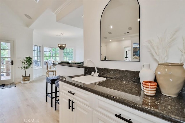 interior space featuring an inviting chandelier, vanity, and hardwood / wood-style floors