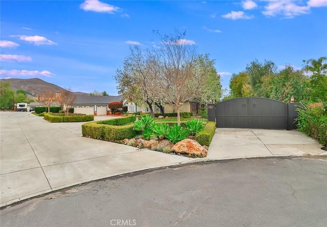 view of front facade featuring a garage and a mountain view