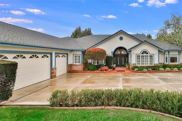 ranch-style home featuring a garage