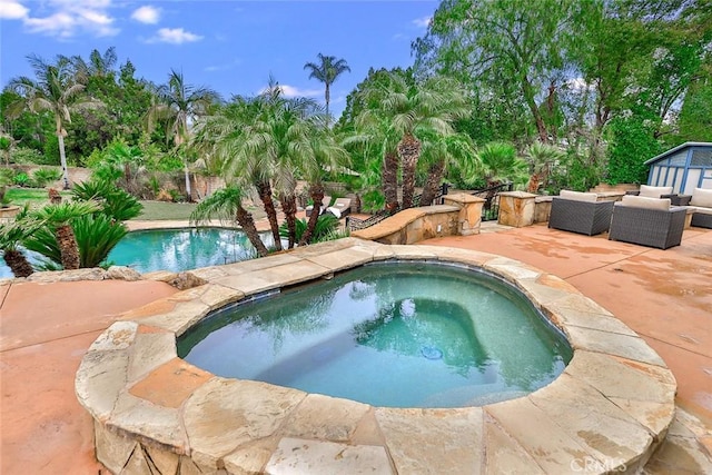 view of pool featuring an outdoor hangout area, a patio, and an in ground hot tub