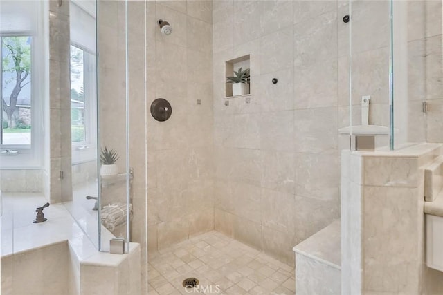 bathroom with a tile shower