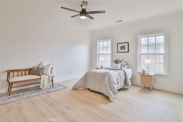 bedroom with ceiling fan, ornamental molding, and light hardwood / wood-style flooring