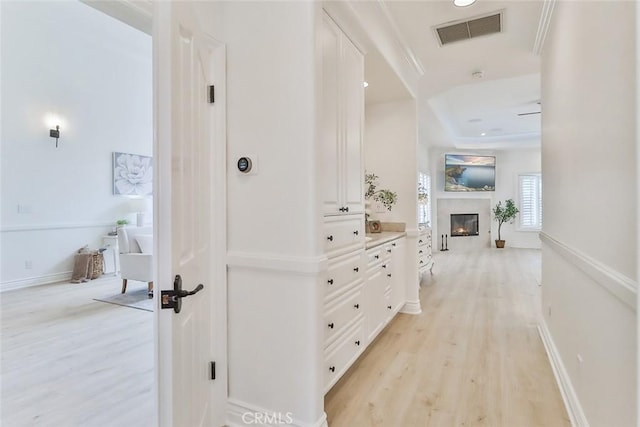 corridor with light hardwood / wood-style flooring