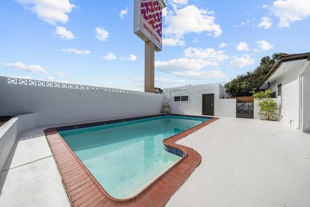 view of swimming pool with a patio area