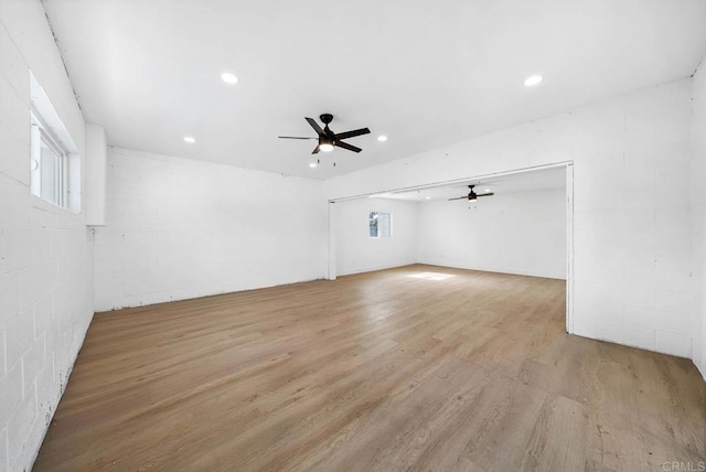 interior space with ceiling fan and light hardwood / wood-style flooring