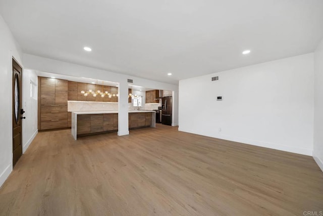 unfurnished living room with light wood-type flooring