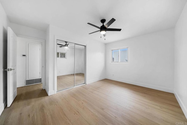 unfurnished bedroom with ceiling fan, light hardwood / wood-style floors, and a closet