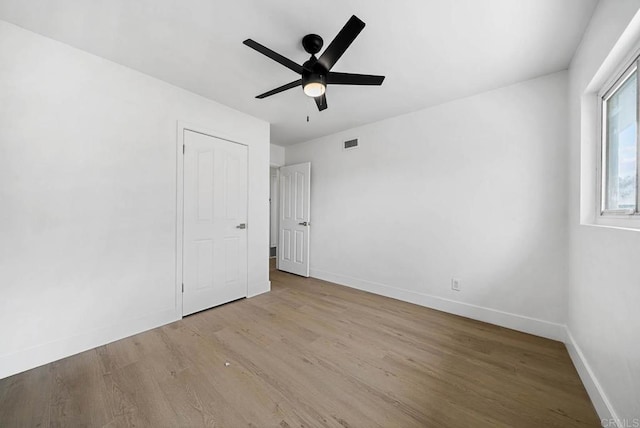 unfurnished bedroom with ceiling fan and light hardwood / wood-style floors